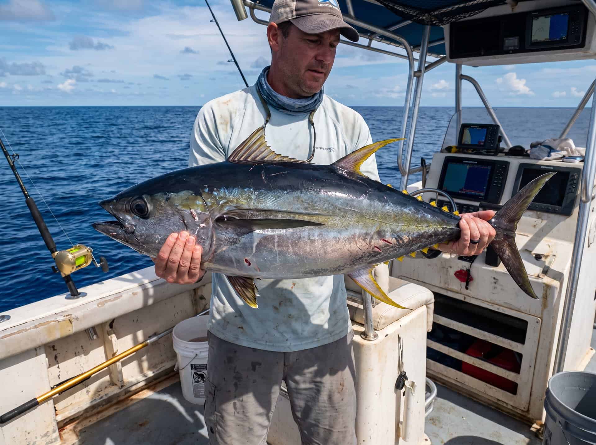 Angler holding Yellowfin Tuna during offshore fishing in Quepos Costa Rica